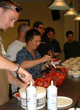 Z-Axis staff serve themselves strawberry shortcake.